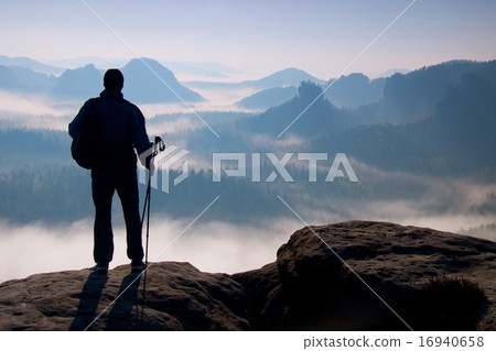 Dark of hiker with poles. Sunny spring daybreak Dark of hiker with poles. Sunny spring daybreak 16940658