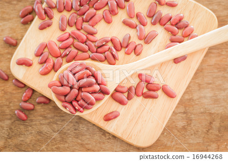 Raw red kidney bean on wooden table Raw red kidney bean on wooden table 16944268