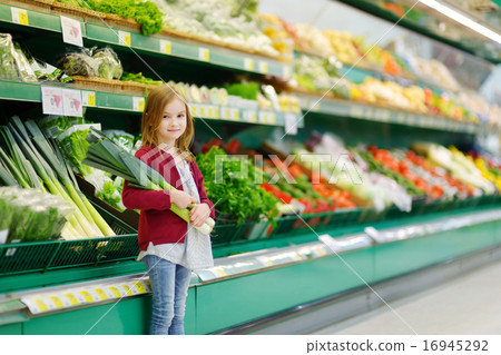 Little girl choosing a leek in a store 16945292