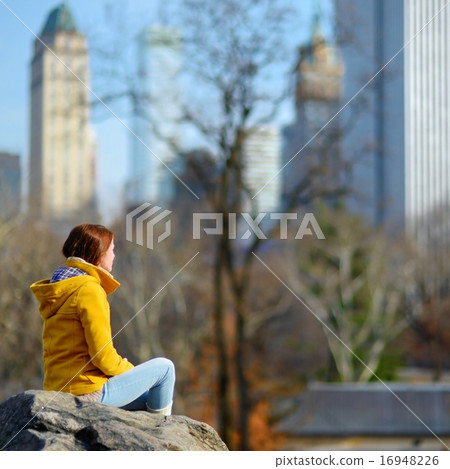 Young woman looking at skyscrapers in Central Park 16948226