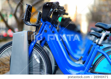 Row of city bikes for rent at docking stations Row of city bikes for rent at docking stations 16948471