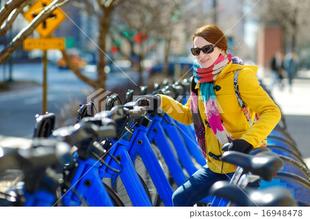 Young beautiful woman ready to rent a city bike 16948478