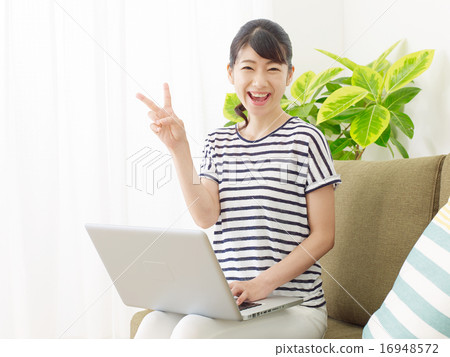 Women peace sign using laptop 16948572