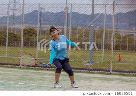 A woman playing tennis A woman playing tennis 16956591