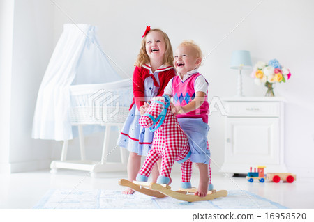 Kids playing with rocking horse Kids playing with rocking horse 16958520