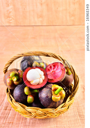 Fresh fruit in a basket on a wooden floor 16968349