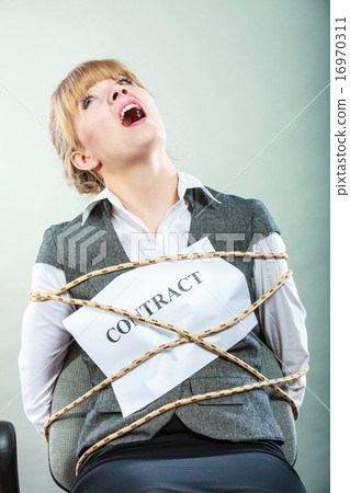Afraid woman bound by contract tied to chair. 16970311