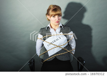 Upset businesswoman bound by contract terms. Upset businesswoman bound by contract terms. 16970312
