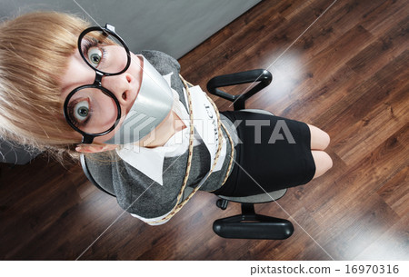 Businesswoman bound by contract with taped mouth. Businesswoman bound by contract with taped mouth. 16970316