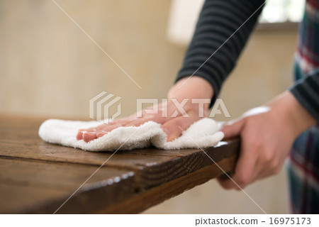 Japanese hands wiping a table with a cloth. Japanese hands wiping a table with a cloth. 16975173