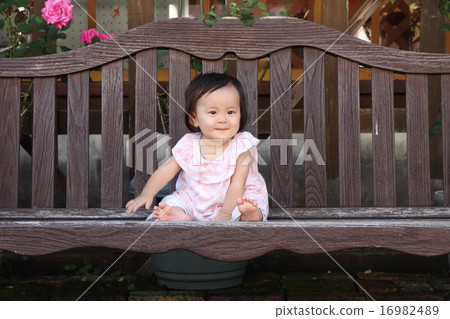 Baby sitting on the bench (0 year old child) Baby sitting on the bench (0 year old child) 16982489