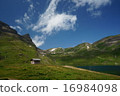 A mountain in Switzerland and a small hut 16984098