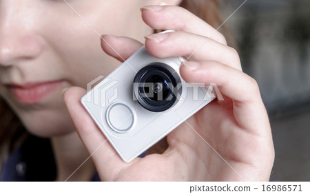 Stock Photo: Young sporty women with unrecognisable action camera in hands