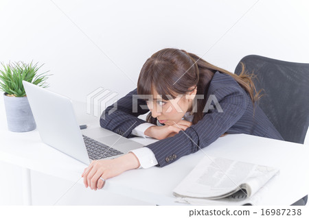 A young business woman nodding at desk 16987238