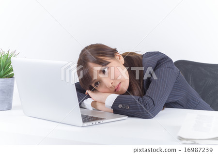 A young business woman nodding at desk 16987239