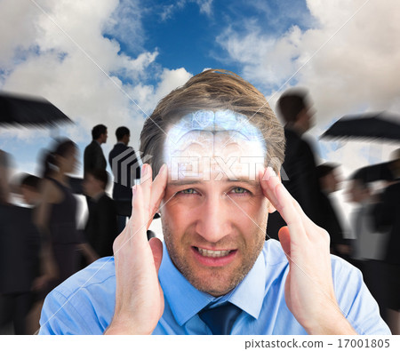 Composite image of young businessman with severe headache Composite image of young businessman with severe headache 17001805