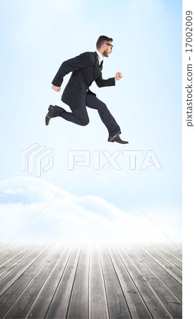 Composite image of geeky young businessman running mid air 17002009