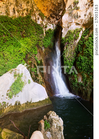 Waterfall in rocky grot Waterfall in rocky grot 17003163