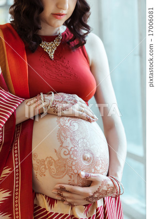 The pregnant woman belly with henna tattoo 17006081