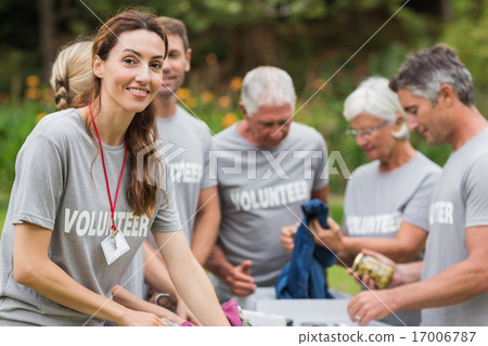 Happy volunteer looking at donation box 17006787