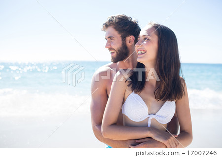Happy couple hugging and looking away 17007246