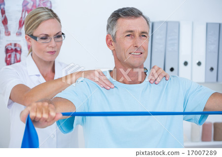 Doctor examining her patient back Doctor examining her patient back 17007289