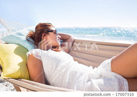 Brunette relaxing in the hammock with sunglasses 17007310