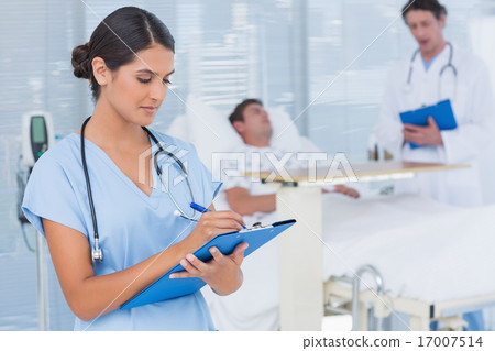 Doctors taking care of patient Doctors taking care of patient 17007514