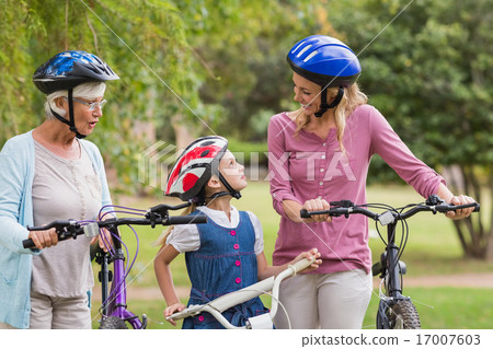 Happy multi generation family on their bike at the park 17007603