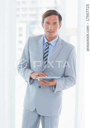 happy businessman using tablet pc 17007728