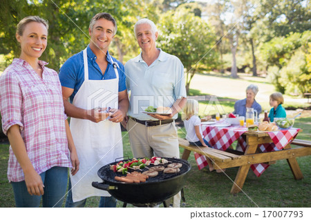 Happy man doing barbecue for his family 17007793