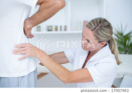 Doctor examining her patient back Doctor examining her patient back 17007963