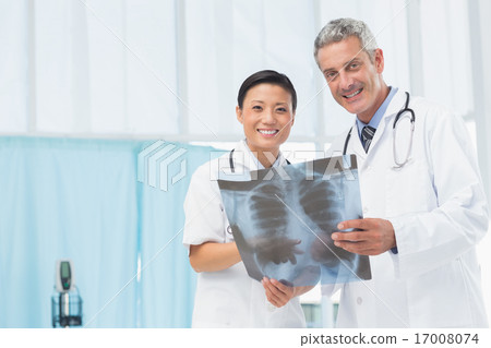 Male and female doctors examining x-ray 17008074