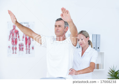 Doctor examining her patient back Doctor examining her patient back 17008238