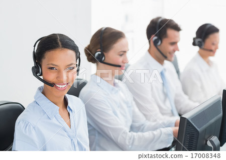 Business people with headsets using computers 17008348