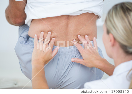 Doctor examining her patient back Doctor examining her patient back 17008540