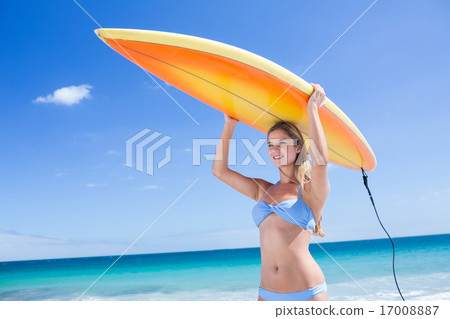 Pretty blonde woman holding surf board Pretty blonde woman holding surf board 17008887