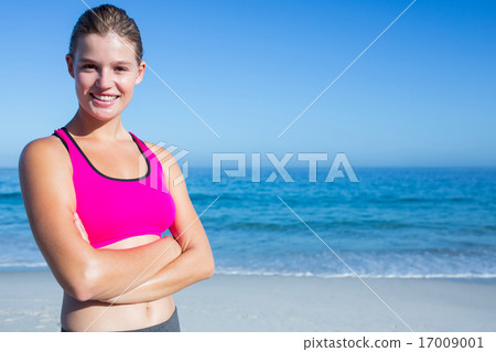 Fit blonde woman standing arms crossed Fit blonde woman standing arms crossed 17009001