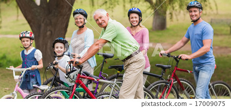 Happy family on their bike at the park Happy family on their bike at the park 17009075