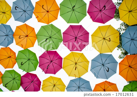 different colored umbrellas hanging in the air 17012631