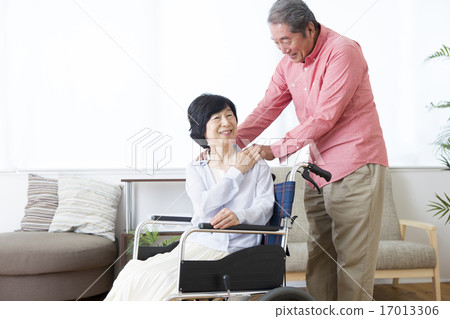 An old couple pushing a wheelchair 17013306