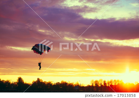 Skydiver On Colorful Parachute In Sunny Sky 17013858