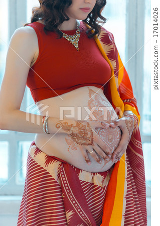 The pregnant woman belly with henna tattoo 17014026