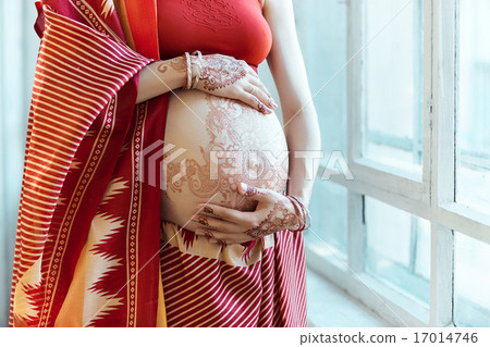 The pregnant woman belly with henna tattoo 17014746