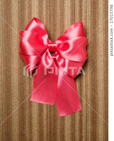 red bow on wooden background 17015798