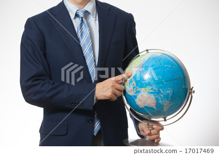 A businessman with a globe A businessman with a globe 17017469