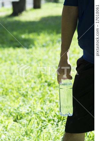 A young man with a plastic bottle 17018061