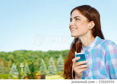 Beautiful girl in park with her phone Beautiful girl in park with her phone 17020359
