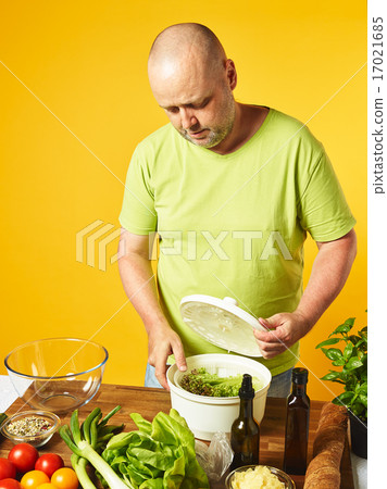 Middle-aged man cook fresh salad Middle-aged man cook fresh salad 17021685