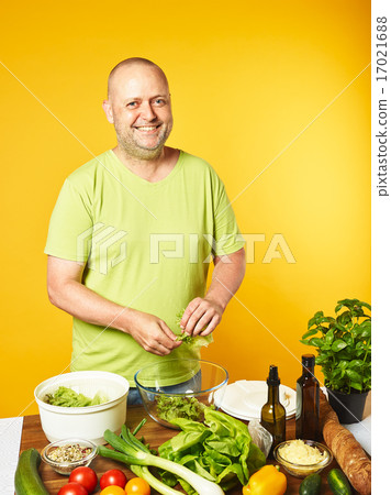 Middle-aged man cook fresh salad Middle-aged man cook fresh salad 17021688